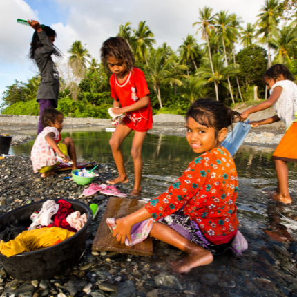 Children gathering at ocean shoreline
